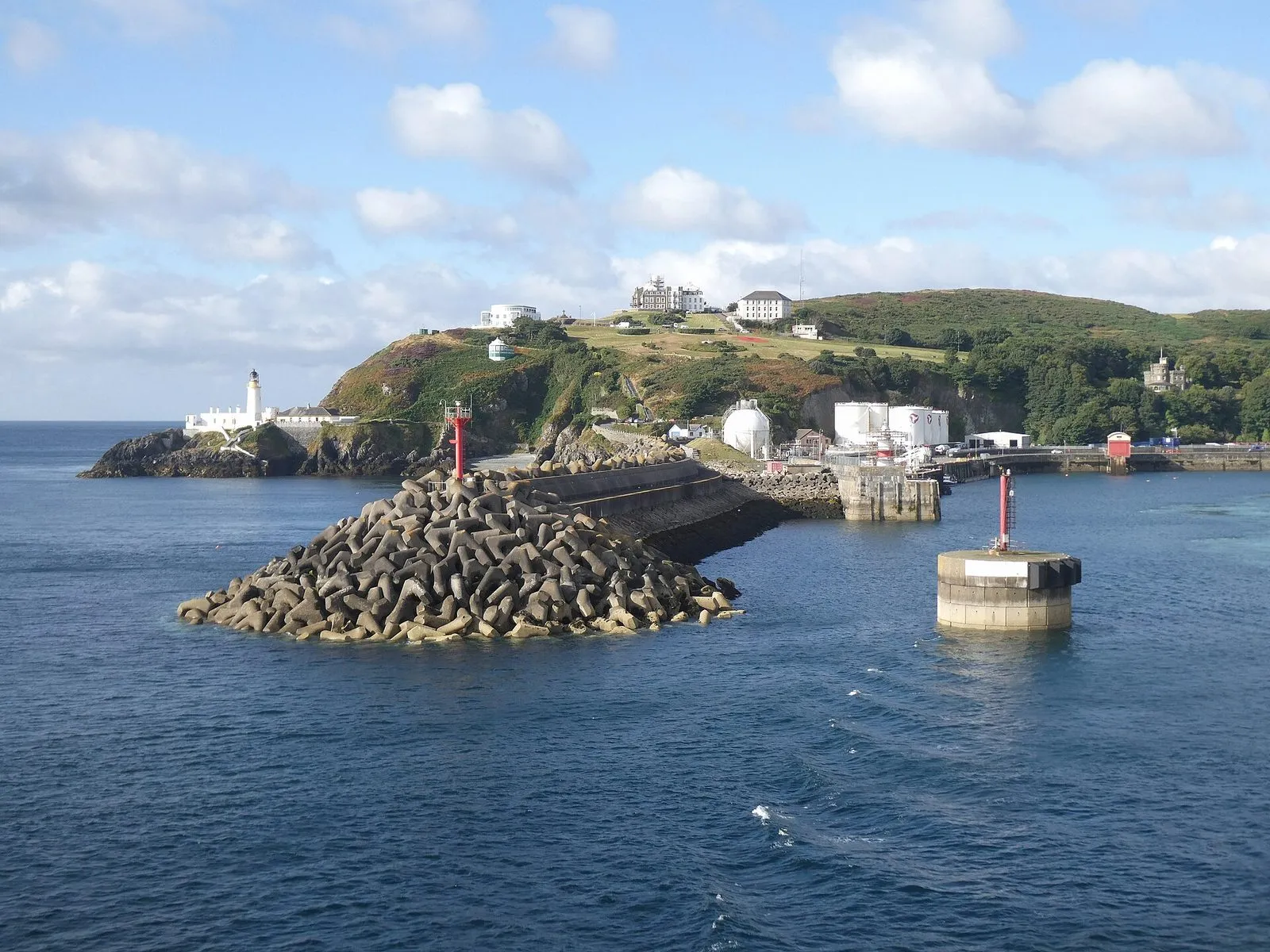 Douglas Harbour breakwater and the lighthouse at Douglas Head, seen from a ferry coming into port on a bright day