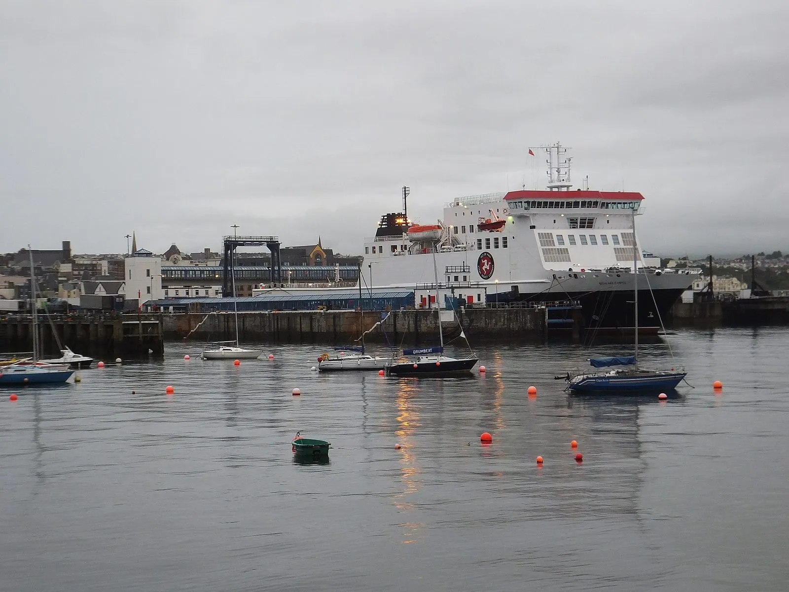 The white-hulled ferry Ben-my-Chree berthed in Douglas Harbour under a grey sky, with small yachts moored in the foreground