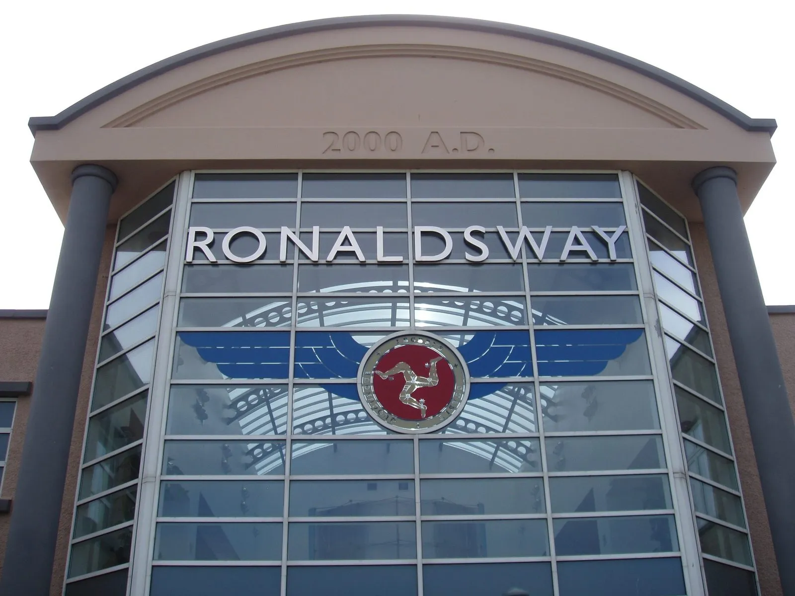 The glass front of the terminal at Ronaldsway, with the word RONALDSWAY and the Three Legs of Man in a winged emblem