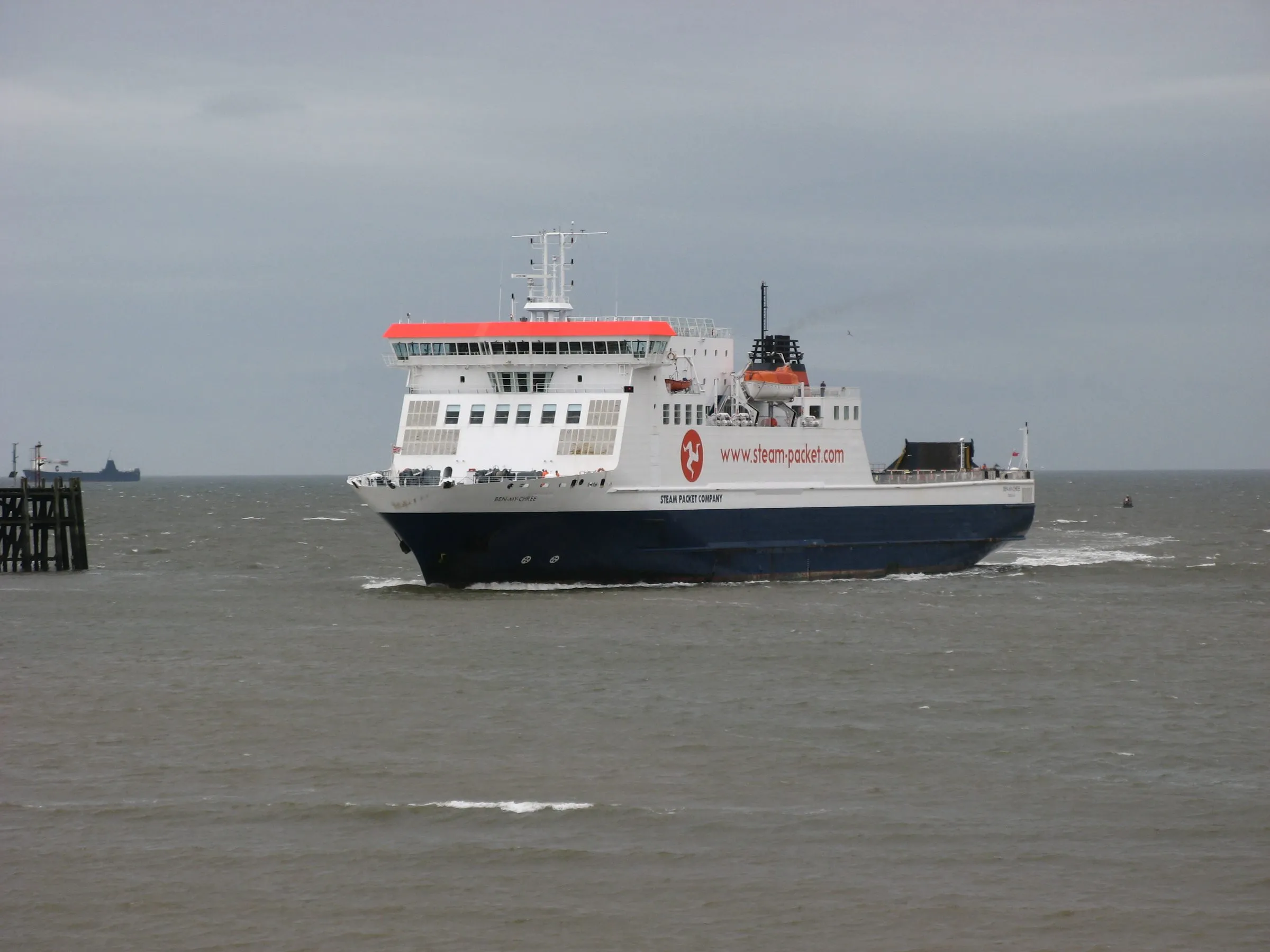 The Steam Packet ferry Ben-my-Chree, white with a dark blue hull, approaching Heysham harbour across a grey, choppy sea