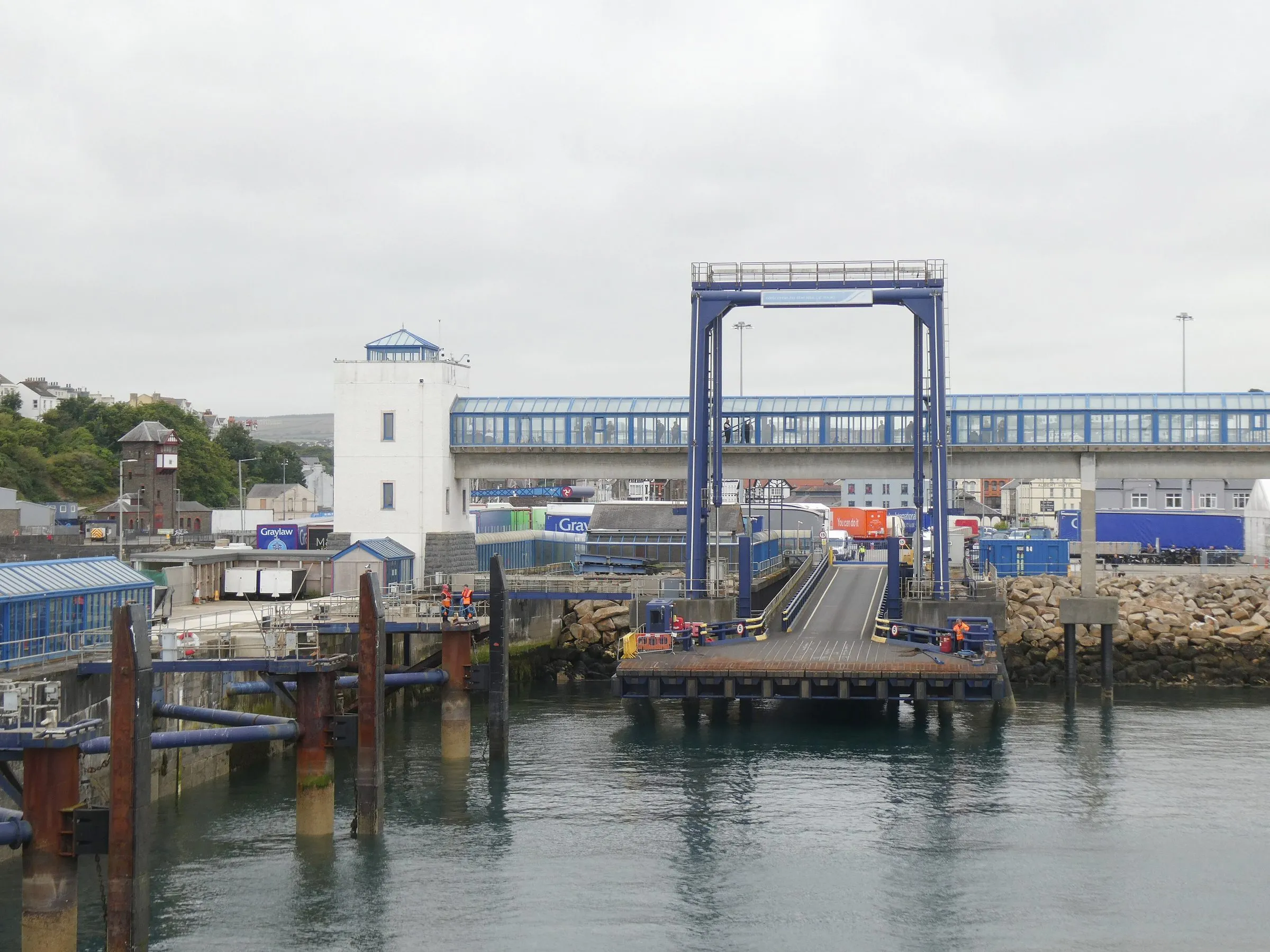 The ferry linkspan on King Edward VIII Pier in Douglas harbour, with freight trailers and containers lined up on the quay behind