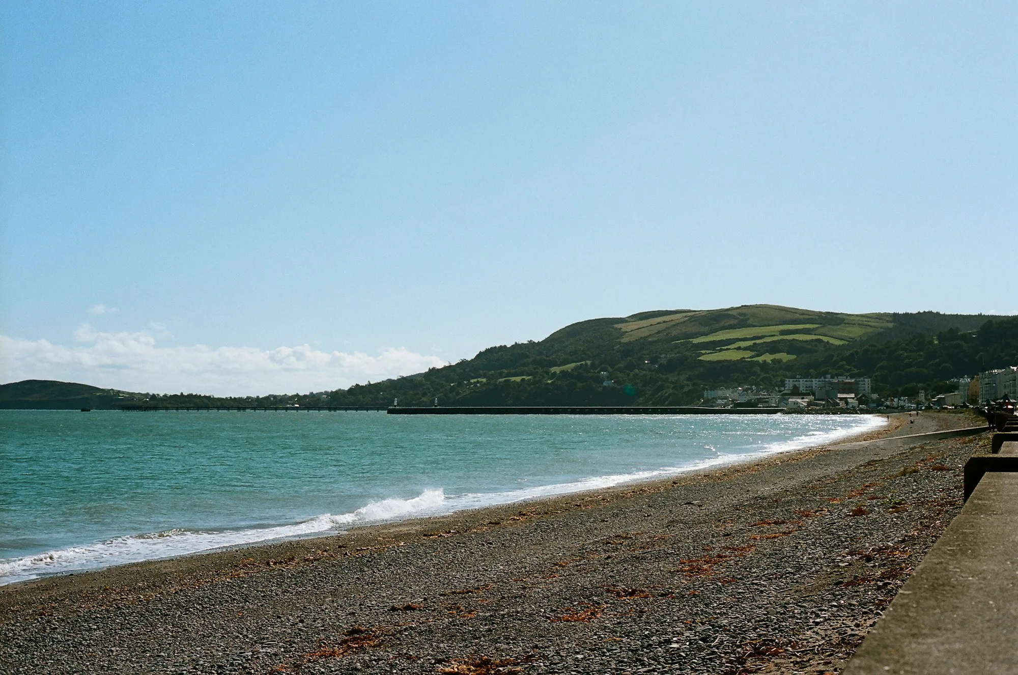 Ramsey's shingle beach curving round the bay towards the green slopes of North Barrule