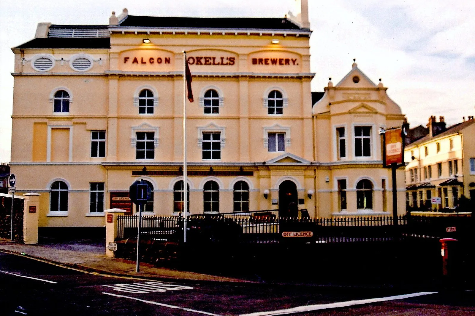 Okell’s former Falcon Brewery in Douglas, a cream Victorian building with the brewery name in red letters across the top