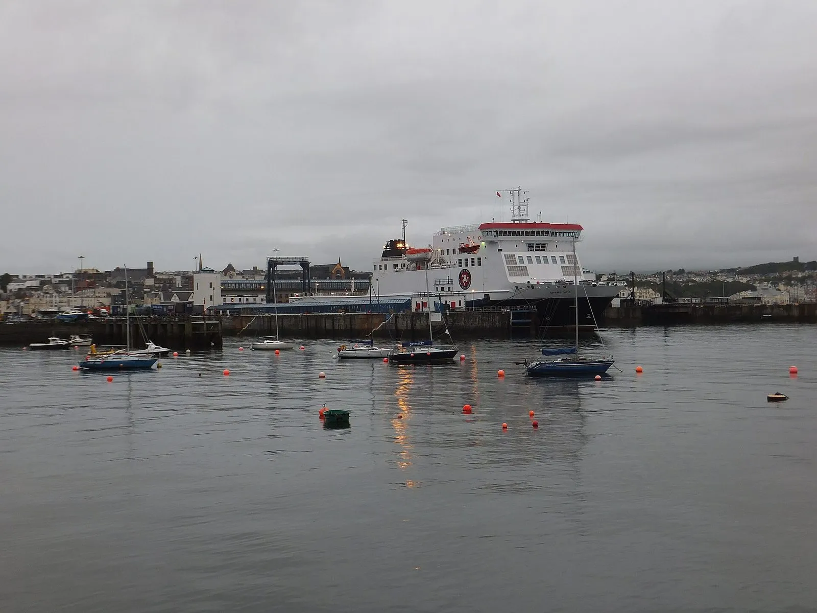 The Steam Packet ferry Ben-my-Chree moored at the linkspan in Douglas harbour on a grey evening, with yachts in the foreground